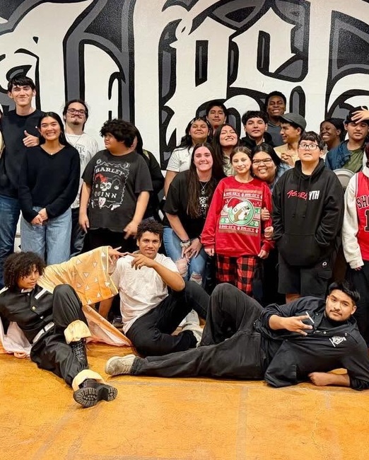 AGORA YTH students gathered in front of the West Side mural at AGORA